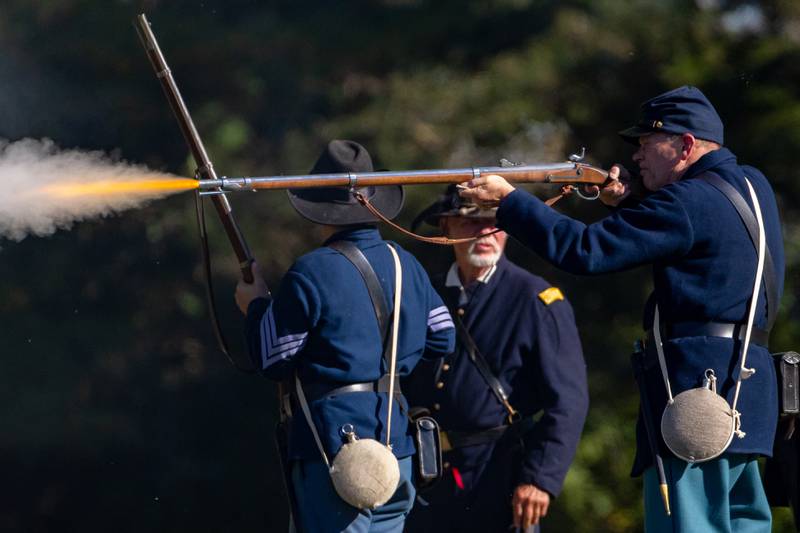 A Union Army soldier fires his musket on the battlefield during the Shadows Of The Blue and Gray Civil War reenactment at City County Park on October 10, 2025 in Princeton.