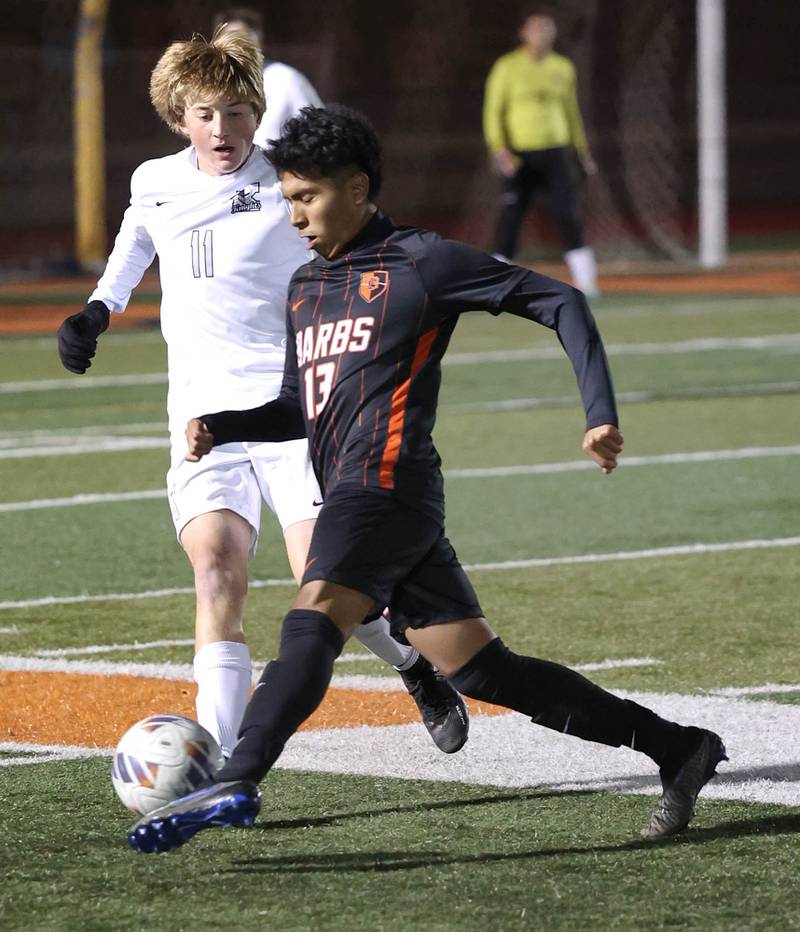 DeKalb’s Henry Garcia Alvarez kicks the ball away from Kaneland's Matthew Mitchinson during their game Thursday, Oct. 12, 2023, at DeKalb High School.