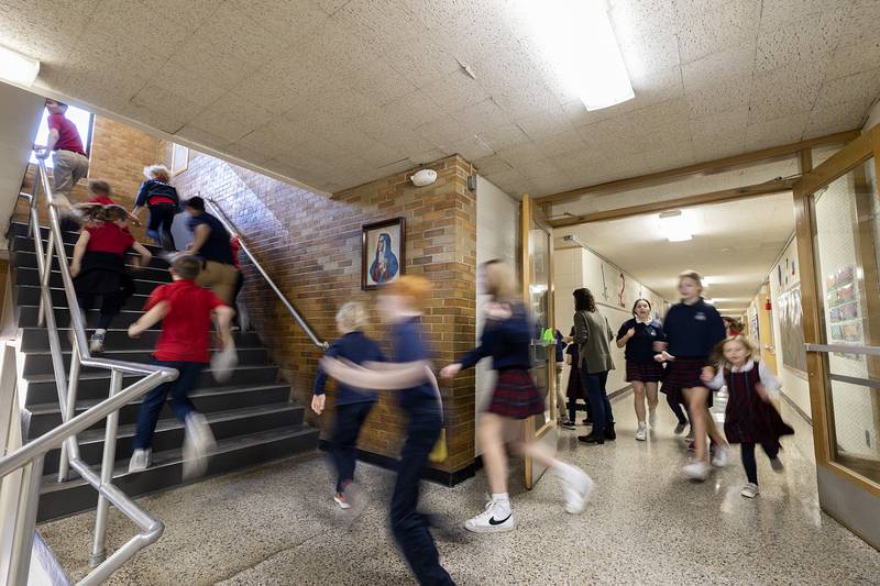 Dixon St. Mary’s school students zip around the hallways as they try and gather items during scavenger hunt Wednesday, Feb. 1, 2023 in celebration of Catholic Schools Week.