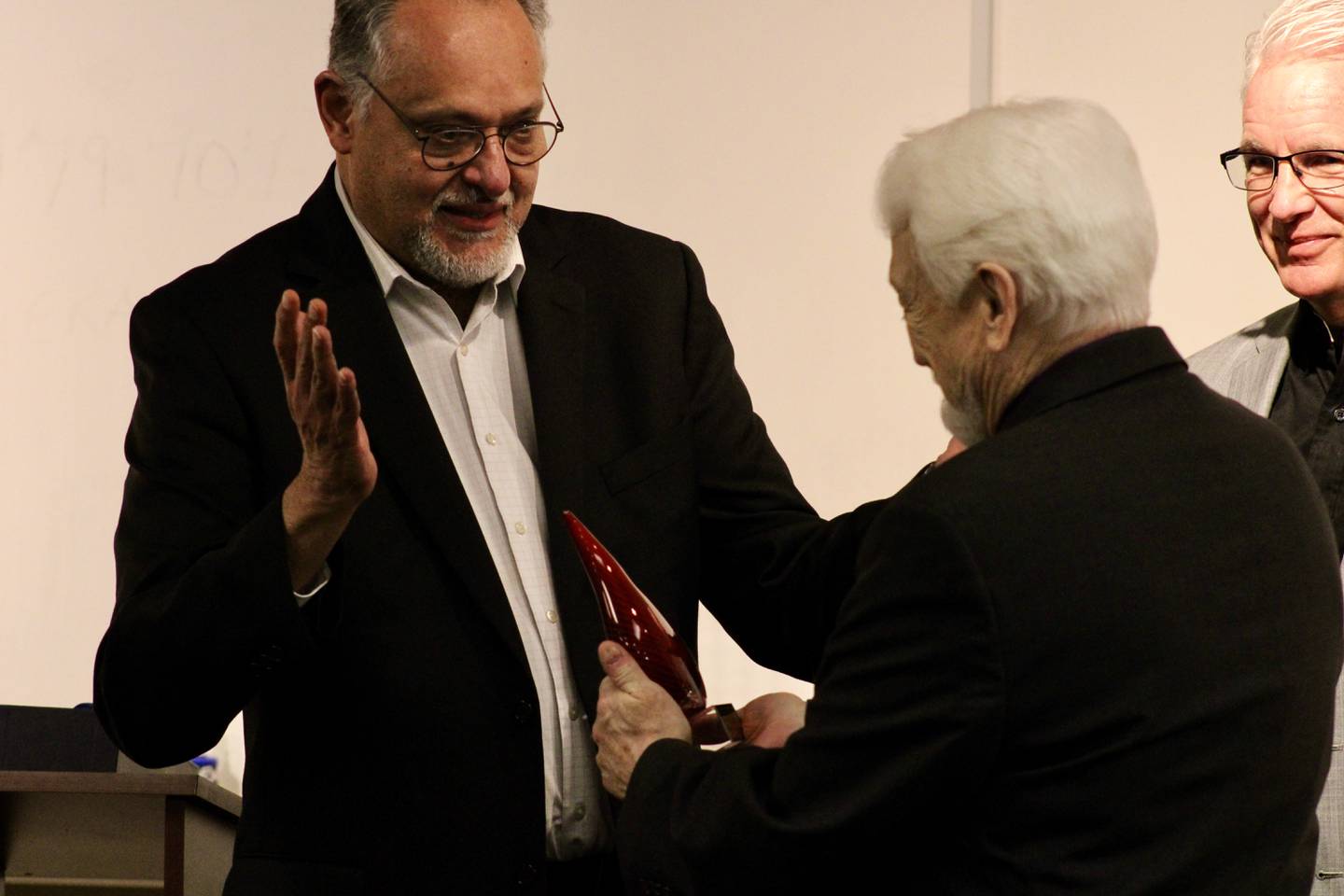 Manny Cordero, director of the Assembly of God Chaplaincy, home missions department, presents Vincent Marrandino with his lifetime achievement award on Friday at the Dixon Public Safety building. About 50 people attended the ceremony.