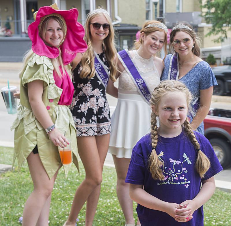 Olivia Moe, 8, of Dixon has her picture taken with the Petunia Fest court Katelyn Fassler (left), as Pinky, attendant Leah Kuehl, queen Kendall Fassler and attendant Esther Whitcombe.