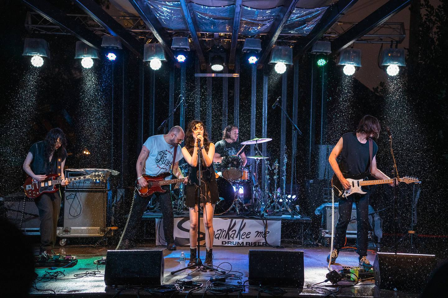Rain pours on the Hill Stage as Chicago-based band Smut performs during Merchant Street MusicFest on Saturday, July 26, 2025.