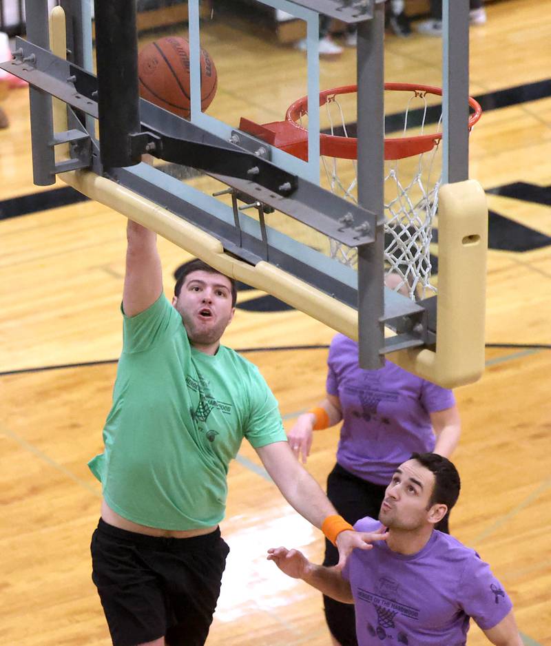 Fire/Police team member Grayson Zepeda goes to the basket against a Sycamore School Staff team member Thursday, Dec. 19, 2024, during the Heroes on Hardwood basketball game at Sycamore High School. The basketball game, which is a fundraiser for the Spartan Food Pantry, pits a team of Sycamore first responders against a squad of Sycamore School District 427 staff.