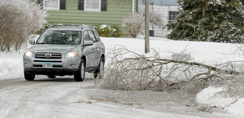 A fallen tree branch partially blocks the road along Sunrise Drive in DeKalb on Wednesday, Dec. 30, 2020.