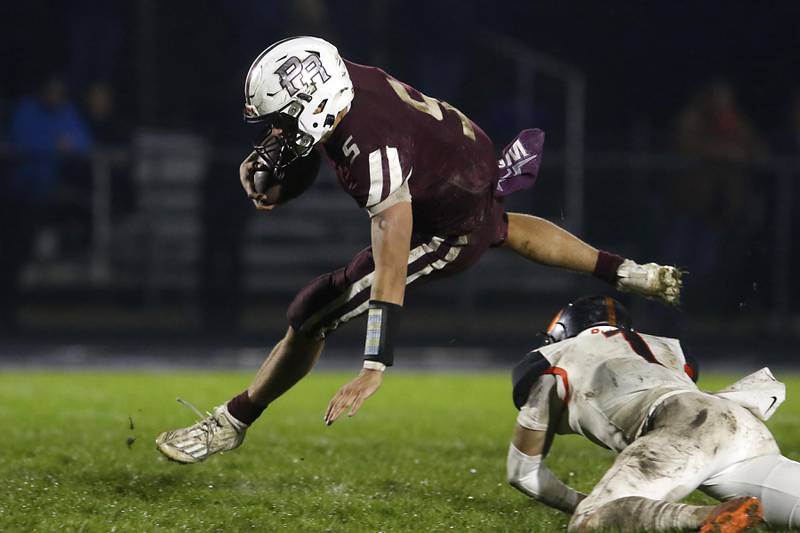 Prairie Ridge's Joseph Vanderwiel tries to leap over Crystal Lake Central's Drake Tomasiewicz during a Fox Valley Conference football game on Friday, Oct. 13, 2023, at Prairie Ridge High School in Crystal Lake.