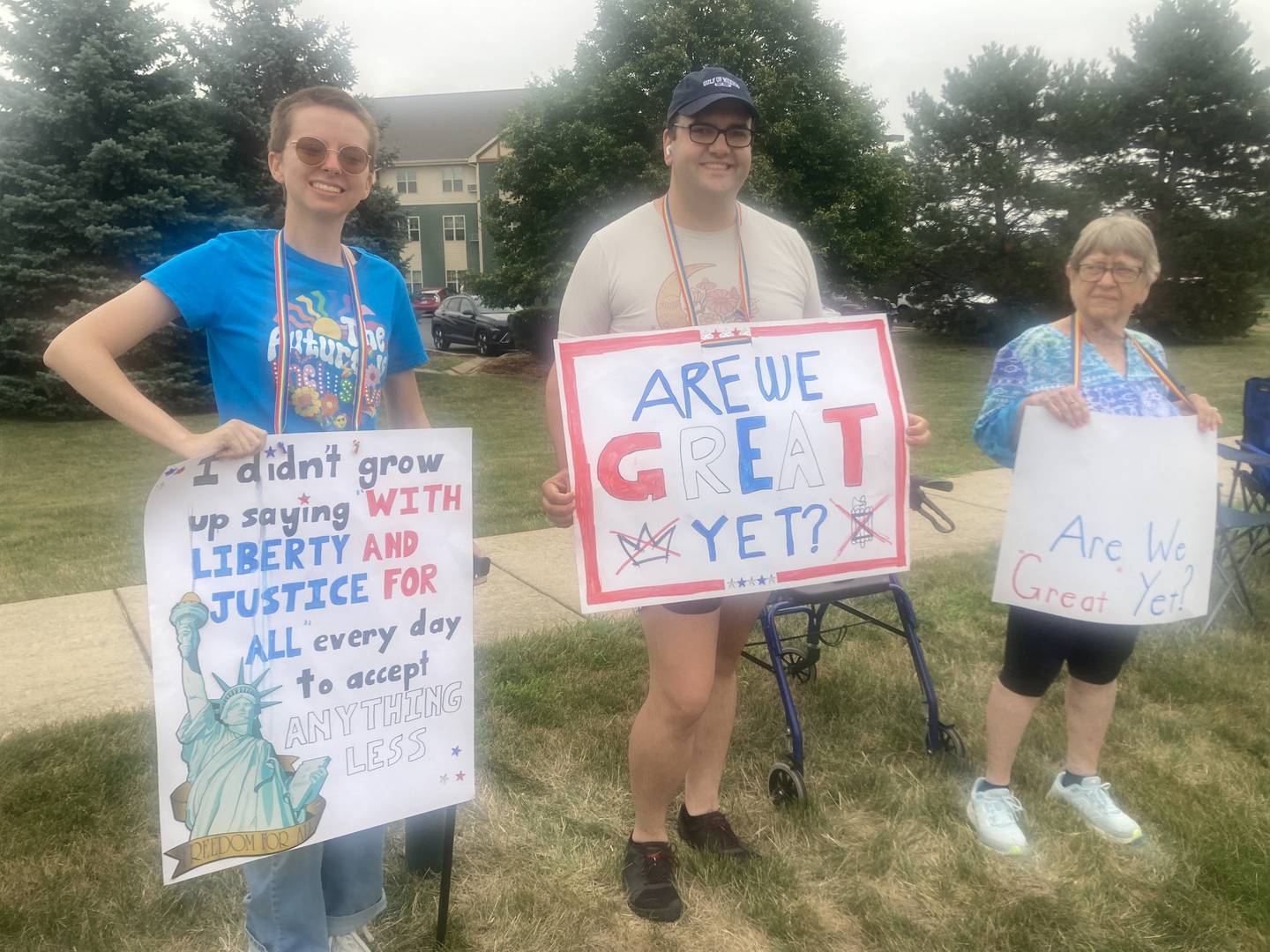 Lee Delaughter and Lexi Miller stand along River Road with their "adoptive grandma" Barbara McIntosh at the "Good Trouble Lives On" protest in Shorewood on Thursday, July 17, 2025.