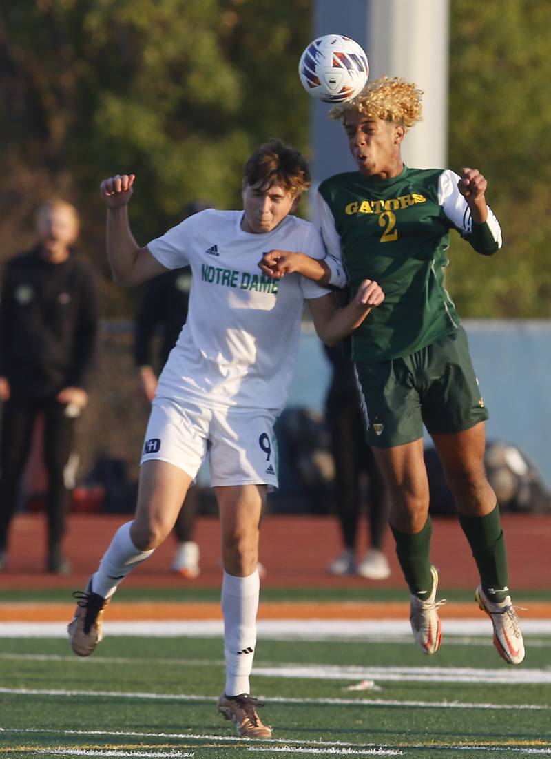 Crystal Lake South's Diego Paguada heads the ball away from Peoria Notre Dame's Declan Schuler during the IHSA Class 2A state championship soccer match on Saturday, Nov. 4, 2023, at Hoffman Estates High School.