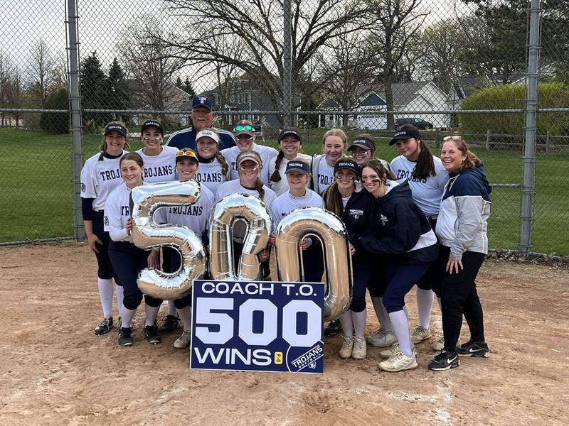 Cary-Grove's softball team celebrates career win No. 500 for coach Tammy Olson after defeating Dundee-Crown 3-2 on Monday.