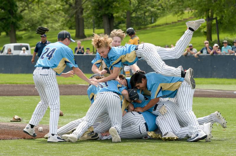 Marquette celebrates tits 4-1 victory over Putnam County for the Class 1A Harvest Christian Sectional title at Judson College in Elgin on Saturday, May 28, 2022.