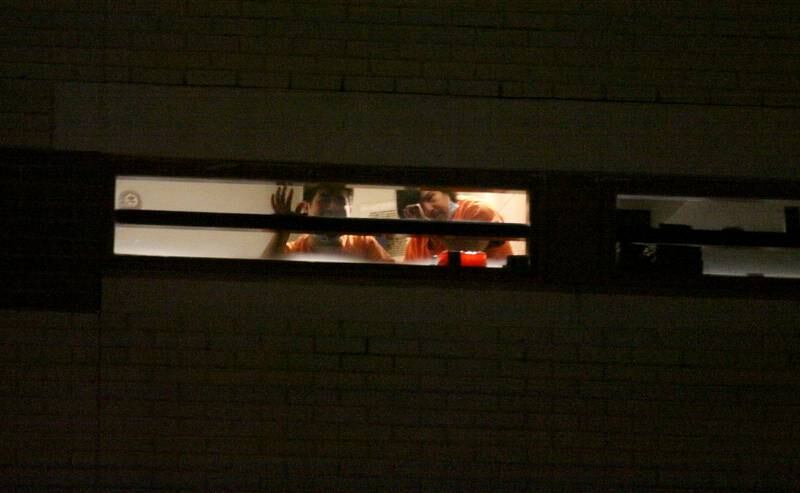 Inmates watch as activists held a candlelight march to the front of the McHenry County Correctional Facility the evening of Wednesday, Dec. 29, 2021. The event was arranged by the Coalition to Cancel the ICE Contract in McHenry County.