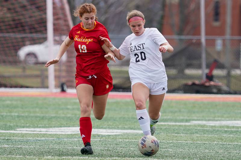 Oswego East's Catie Sloan (20) plays the ball against Batavia’s Addison Wujciga (19) during a soccer match at Batavia High School on Saturday, March 29, 2025.