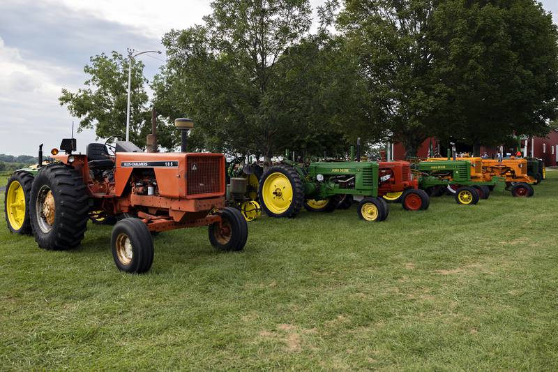 A row of antique tractors sit on display Wednesday, August 6, 2025, at the Carroll County Fair