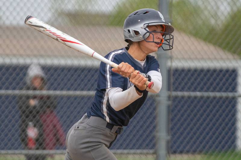 Oswego East's May Pasqualini (3) singles driving in two runs against West Aurora during a softball game at Oswego East High School on Monday, May 8, 2023.