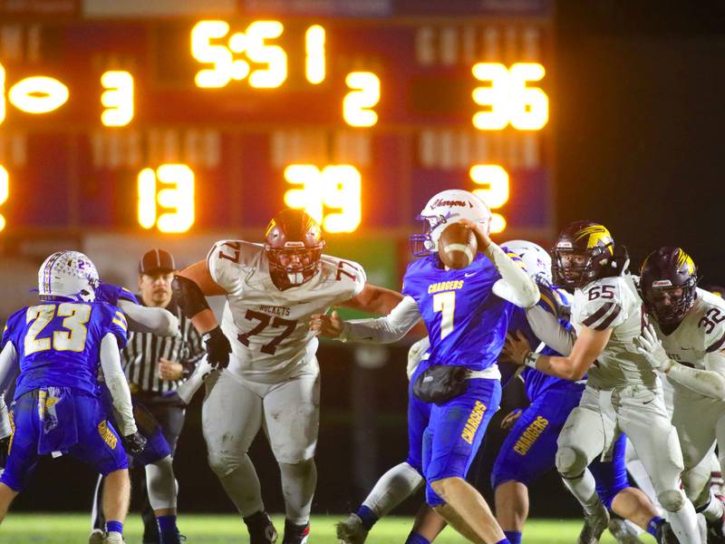 Richmond-Burton’s Nathan Labay (77), Trevor Szumanski (65), and Breckin Campbell (32) close in on Aurora Central Catholic quarterback Grant Bohr in IHSA football Class 3A second-round playoff action at Bob Stewart Field on the campus of Aurora Central Catholic High School in Aurora on Friday, November 7, 2025.