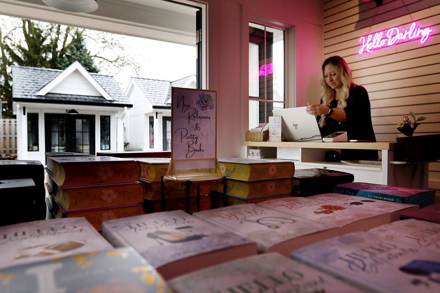 Tina Bree, the owner of Hello Darling Books and Beyond, works on setting up her point of sale program in her tiny shop on Friday, April 25, 2025, at the McHenry Riverwalk Shoppes. The shops open for the 2025 season on May 2.