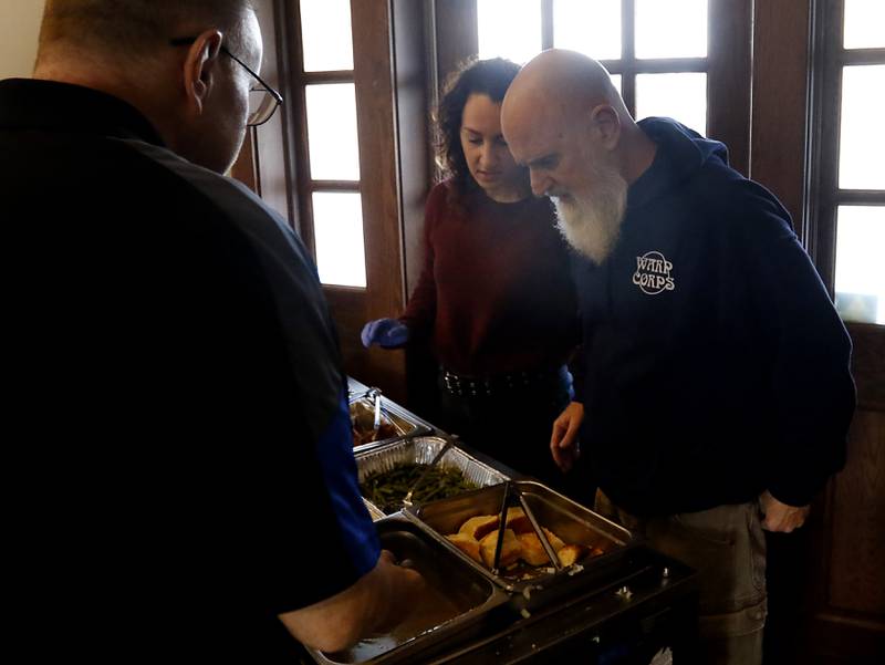 Rob Mutert, founder of Warp Corps., checks on the food during a free pre-Thanksgiving luncheon on Wednesday, Nov. 22, 2023, at the Woodstock train depot. This is the second year the meal that was provided through efforts of Warp Corps, MBI Cares, Isabel’s Family Restaurant, and Napoli’s Pizza, all located in Woodstock