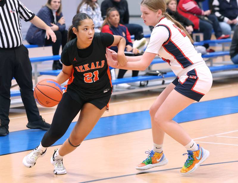 DeKalb’s Alicia Johnson drives around Belvidere North's Samantha Adams during their game Friday, Nov. 17, 2023, in the Mark Einwich Varsity Girls Basketball Rockets Kickoff Tournament at Burlington Central High School.