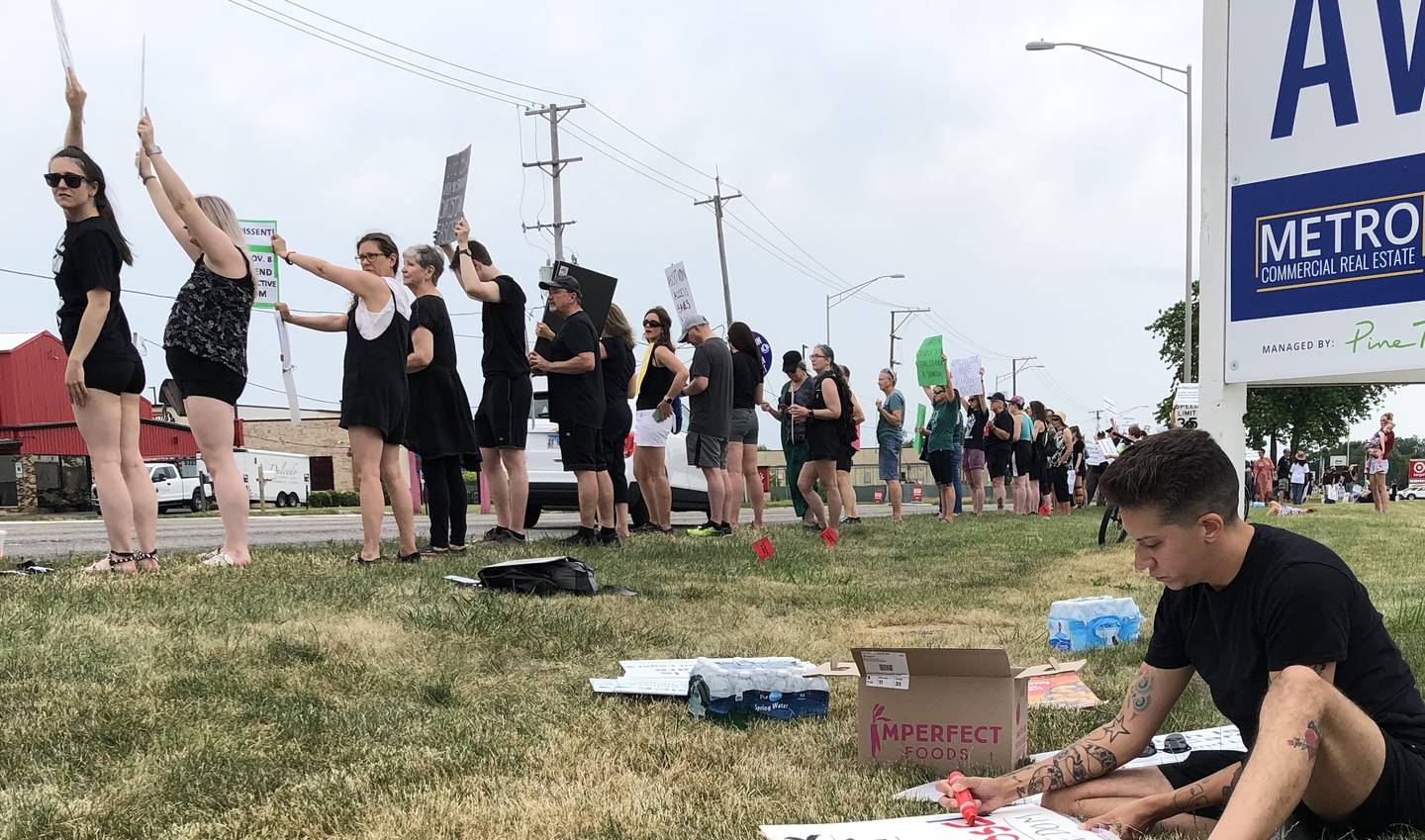 Protesters gathered Monday, July 4, 2022, on Route 14 in Crystal Lake to rally against the decision overturning Roe v. Wade in late June.