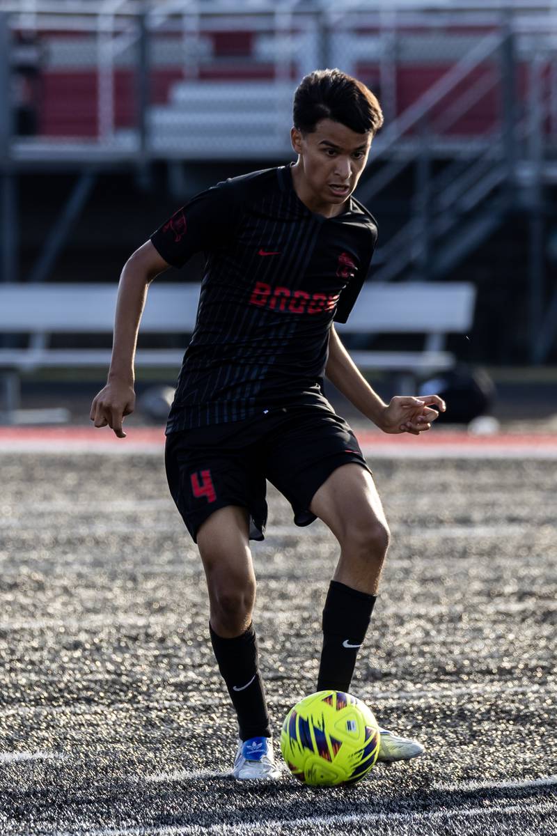 Bolingbrook's Diego Alarcon takes control of the ball during a varsity soccer game in Bolingbrook on Sept. 16, 2025.