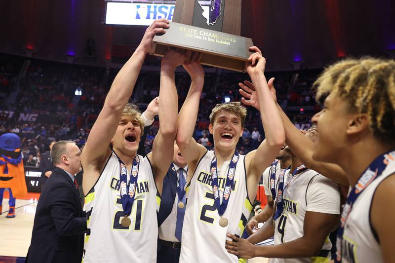 Yorkville Christian’s Elijah Fisher (21) and Jaden Schutt (2) hold up the championship trophy after their 54-41 win over Liberty in the Class 1A championship game at State Farm Center in Champaign. Friday, Mar. 11, 2022, in Champaign.
