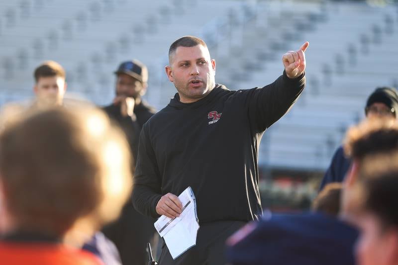 Plainfield North’s head coach Anthony Imbordino goes over instructions before the start of the IHSA Southwest Suburb Showcase combine on Thursday, May 7, 2026 at Plainfield North High School.