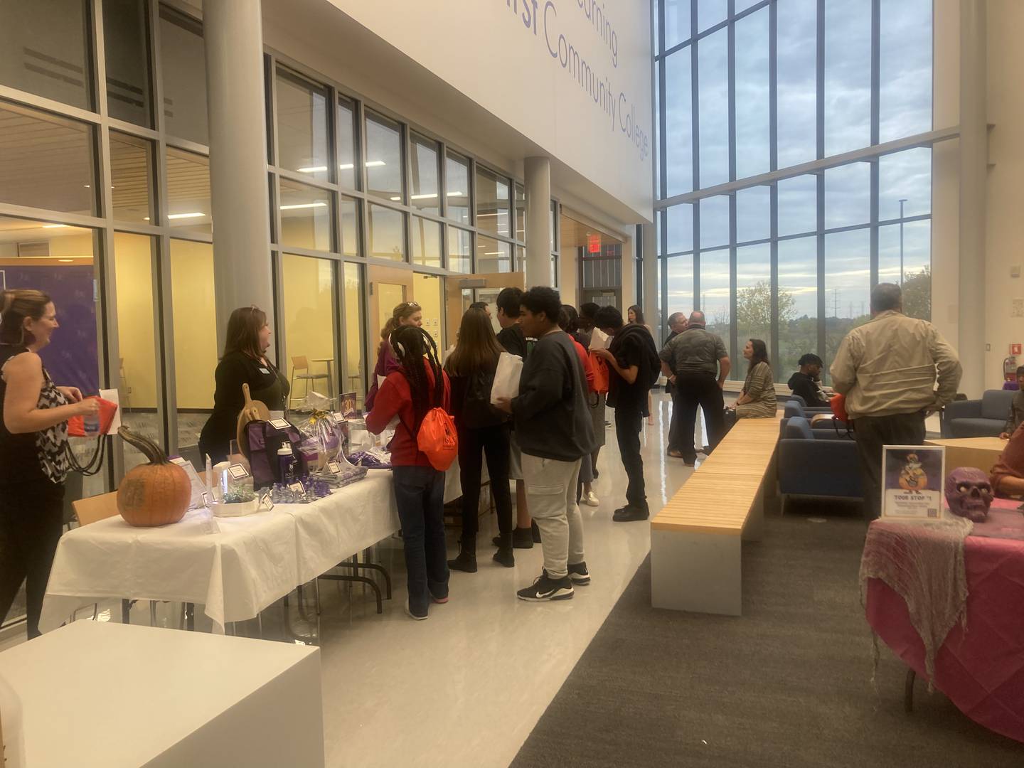 Open house attendees gathered at raffle table.