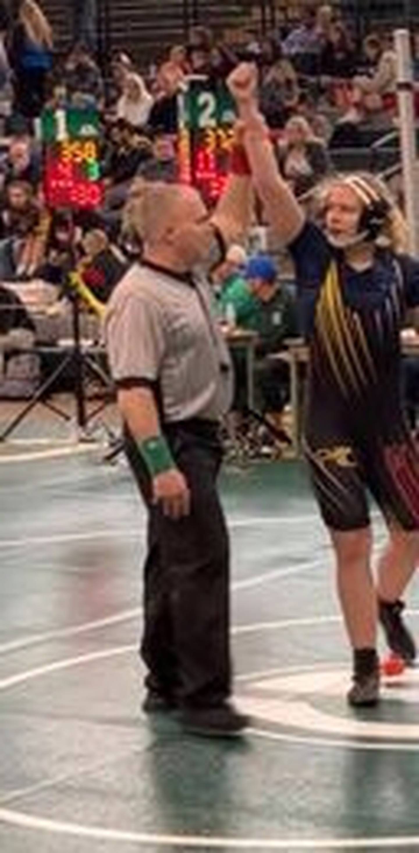 PC-Hall wrestle Bailey Herr has her hand raised in triumph at the Geneseo Regional.