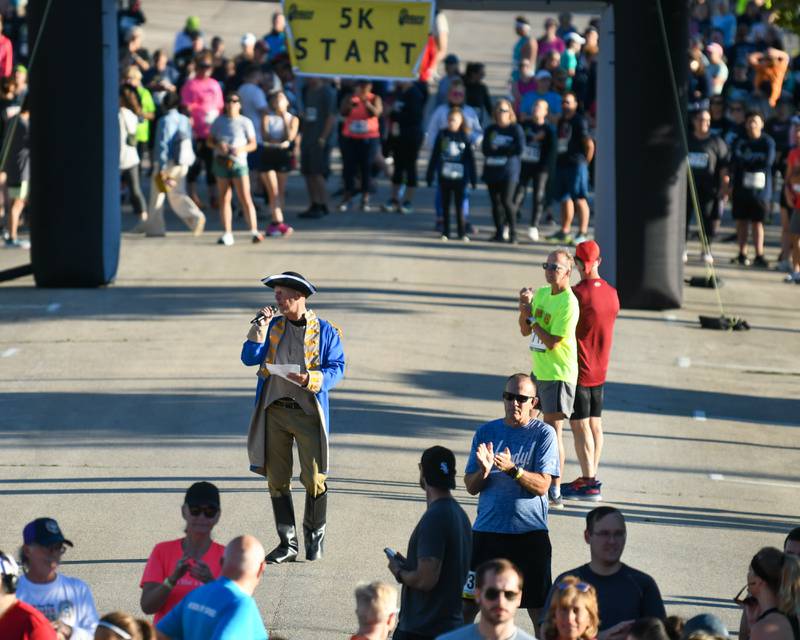 Justin Carlson, dressed as Baron Johann DeKalb, speaks before the start of the DeKalb Corn Classic 5K/10K on Sunday, Sept. 29, 2024, held in downtown DeKalb.
