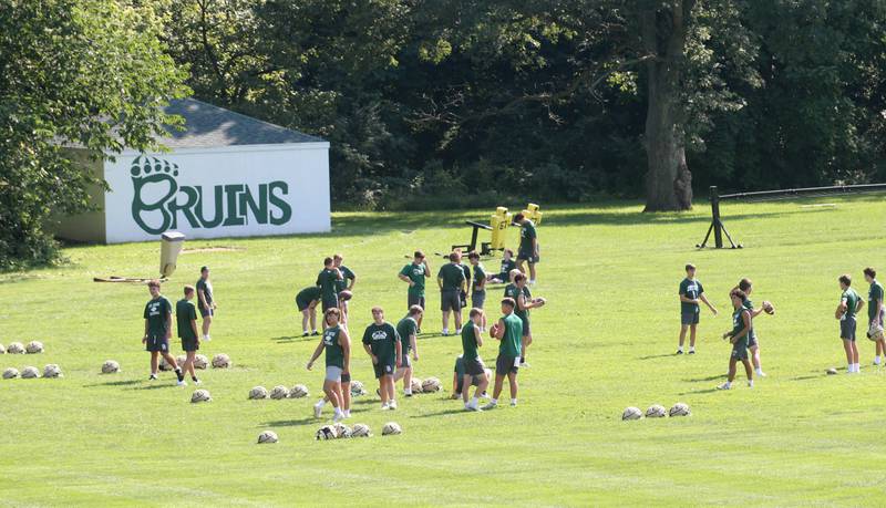 Members of the St. Bede football team gather during the first day of football practice on Monday, Aug. 11, 2025 at St. Bede Academy.