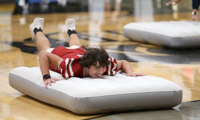 Putnam County High School student Dylan Glynn belly flops on an air matress during the football Homecoming Pep Rally on Friday, Sept. 27, 2024 at Putnam County High School in Granville.