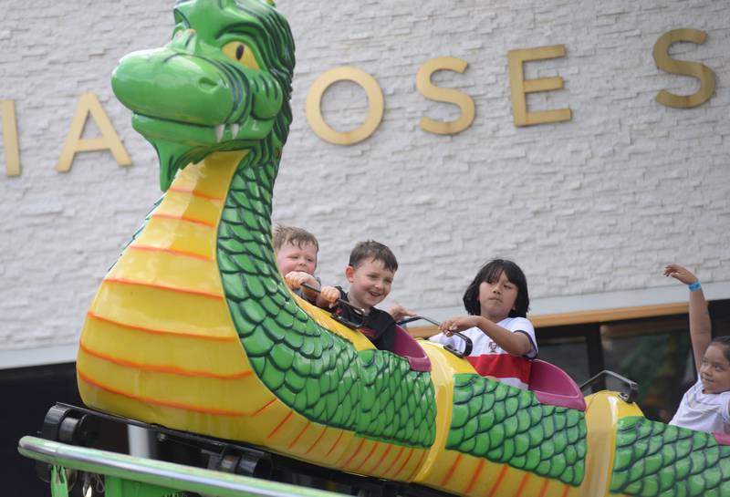 Children including Landon and Miles Kramer of LaGrange Park enjoy riding the Dragon Wagon during the Taste of Westmont Saturday July 12, 2025.