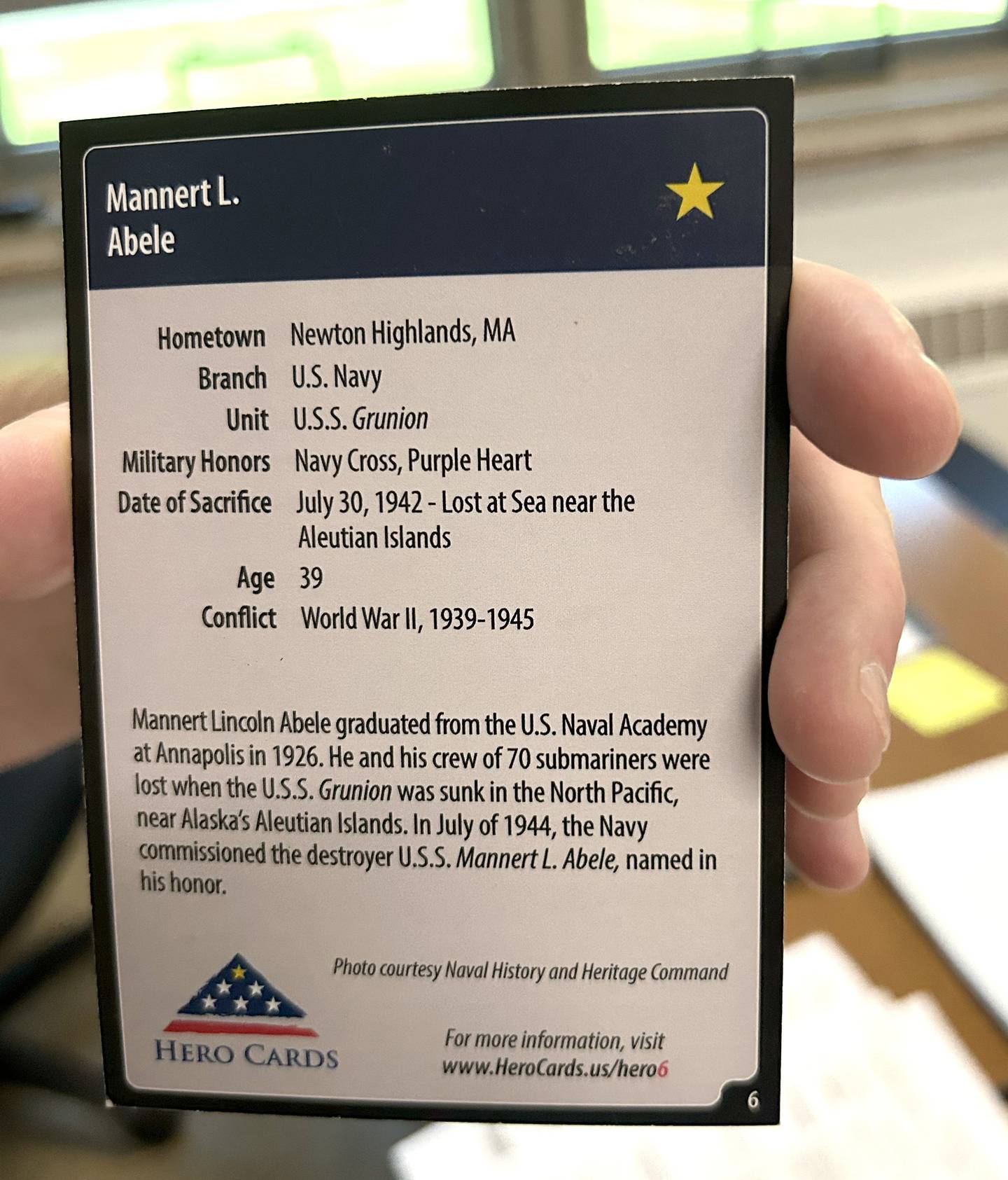 Social studies teacher Jeff Bargar holds one of the "Hero Cards" on Thursday, May 15, 2025 during presentations by his students as part of The Grateful Nation Project.