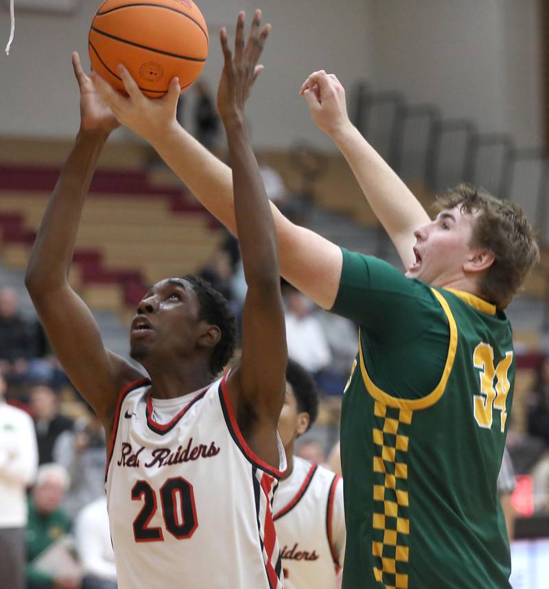 Crystal Lake South's Johnathan Morgan (right) tries to grab a rebound over Huntley's Isaiah Onu during a Fox Valley Conference boys basketball game on Wednesday, Dec. 10, 2025, at Huntley High School.