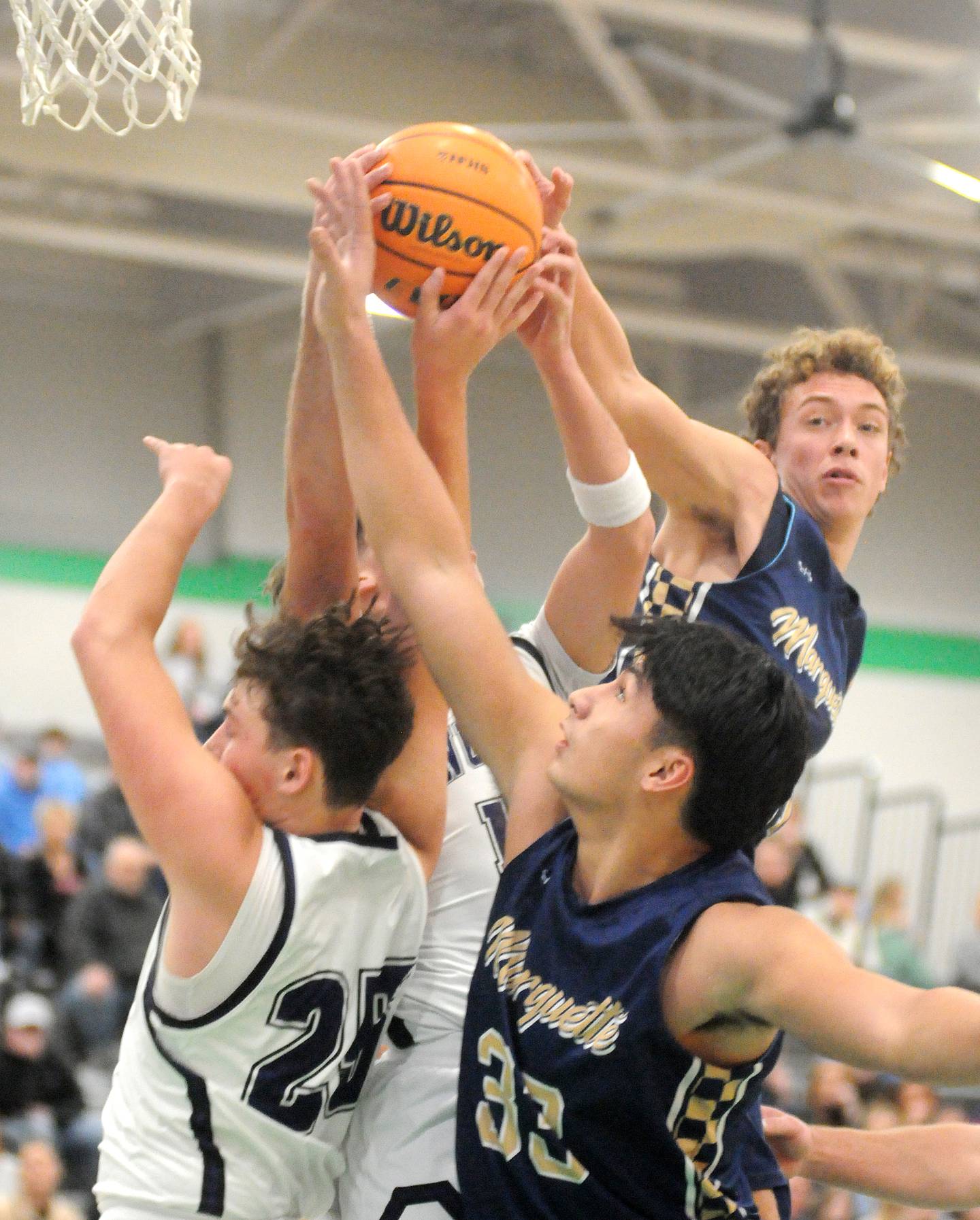 Lexington's Camden McCue (25) and Marquette's Blayden Cassel (33) and Lucas Craig battle for a rebound in the Shipyard Showdown semifinals on Friday, Dec. 26, 2025 in Seneca.