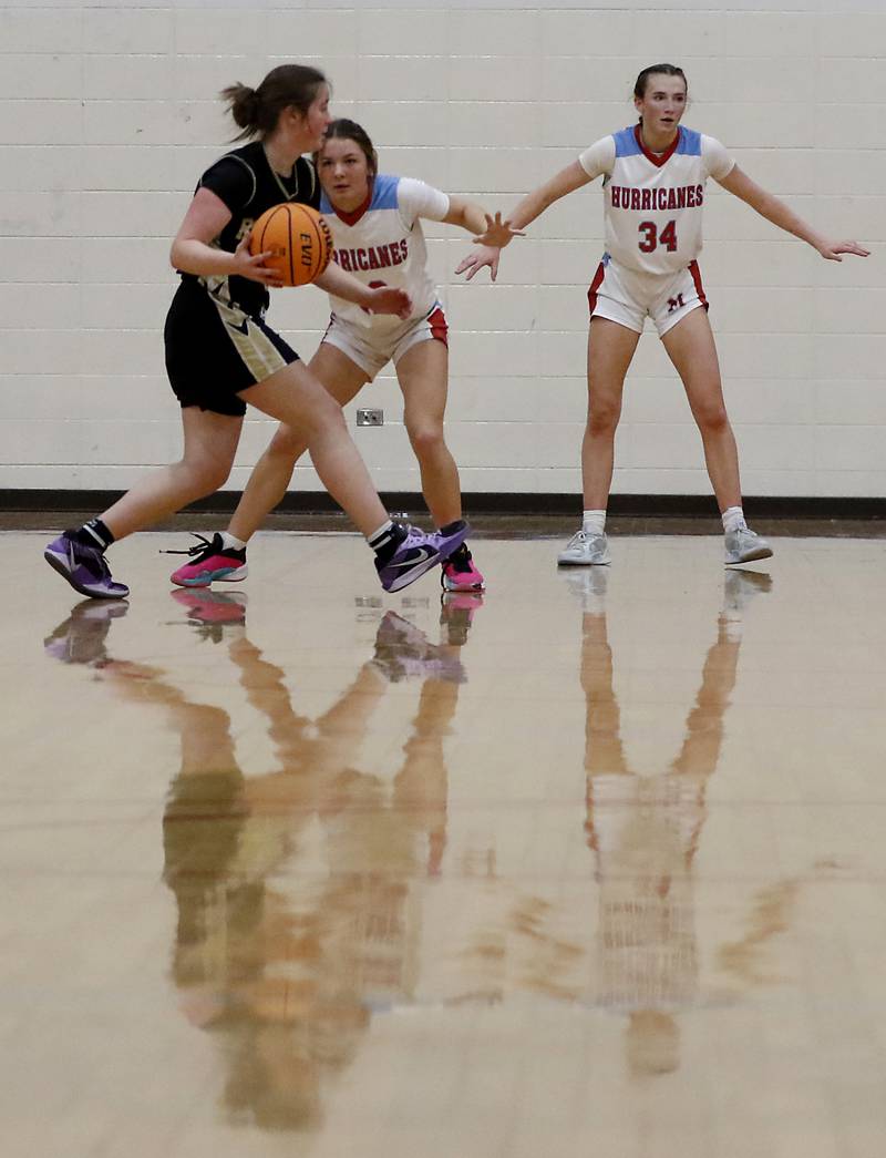 Rockford Christian's Jaden Conerly looks to pass the ball as she is defended by Marian Central's Jenna Remke during a nononference basketball game on Monday, Feb. 10, 2025, at Marian Central High School  in Woodstock.