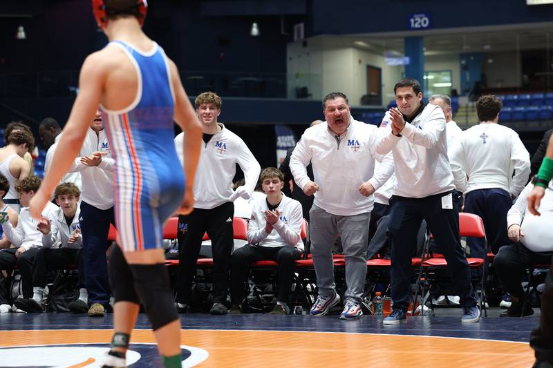 Marmion Academy coaches cheer on Logan Conover in his 144-pound match against Montini's Isaac Mayora during Marmion Academy's victory over Montini in the IHSA Class 3A Dual Team State championship on Saturday, Feb. 28, 2026.