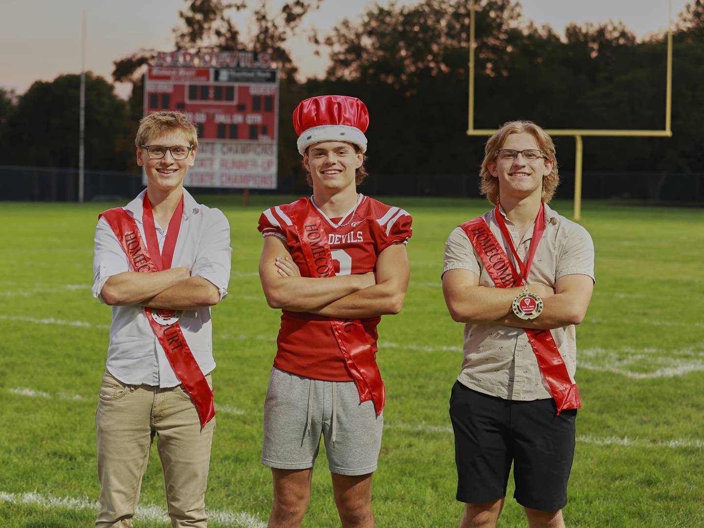 (From left) Second runner-up Logan Corsolini, homecoming king Gianni Guerrini and first runner-up Luke Orlandi pose for a homecoming court photo Friday, Sept. 29, 2023, during Hall High School homecoming football game.