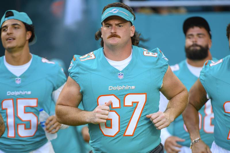 Miami Dolphins offensive lineman Dan Feeney runs onto the field with the team before the start a preseason game against the Atlanta Falcons, Friday, Aug. 11, 2023, in Miami Gardens, Fla.