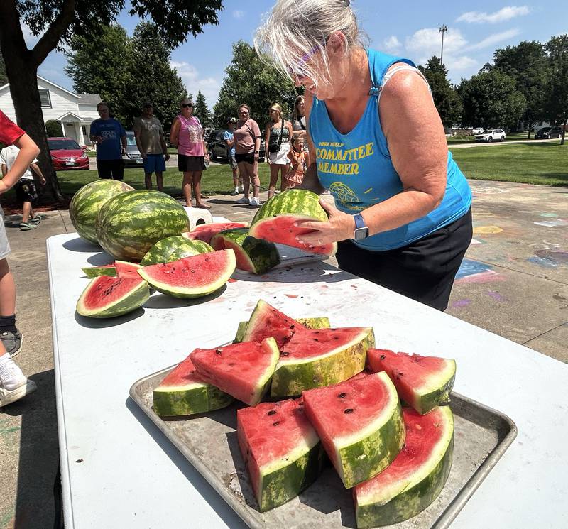 Kathy Bickford cuts melons for the watermelon-eating contest at Sauerkraut Days in Forreston on Saturday, Aug. 2, 2025.