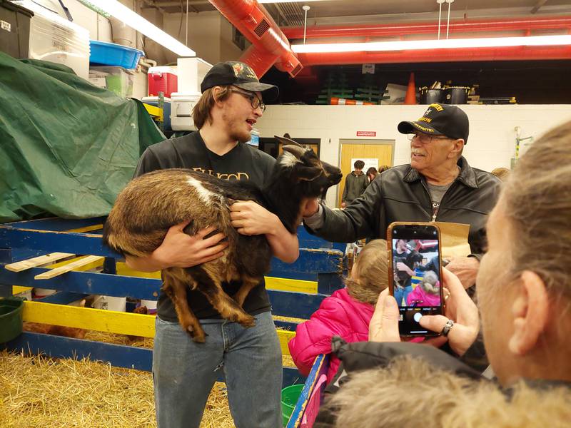 Jaxin Goodrich holds a goat for an audience Tuesday, March 26, 2024, at the Streator FFA's annual animal fair at the high school.