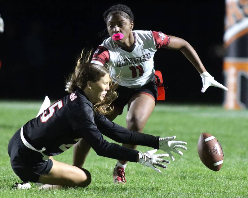 Huntley’s Evelyn Freundt, front, tries to corral the ball as Antioch’s Sasha Johnson closes in during IHSA Regional varsity flag football action at Crystal Lake Central High School in Crystal Lake on Wednesday, Oct. 8, 2025.