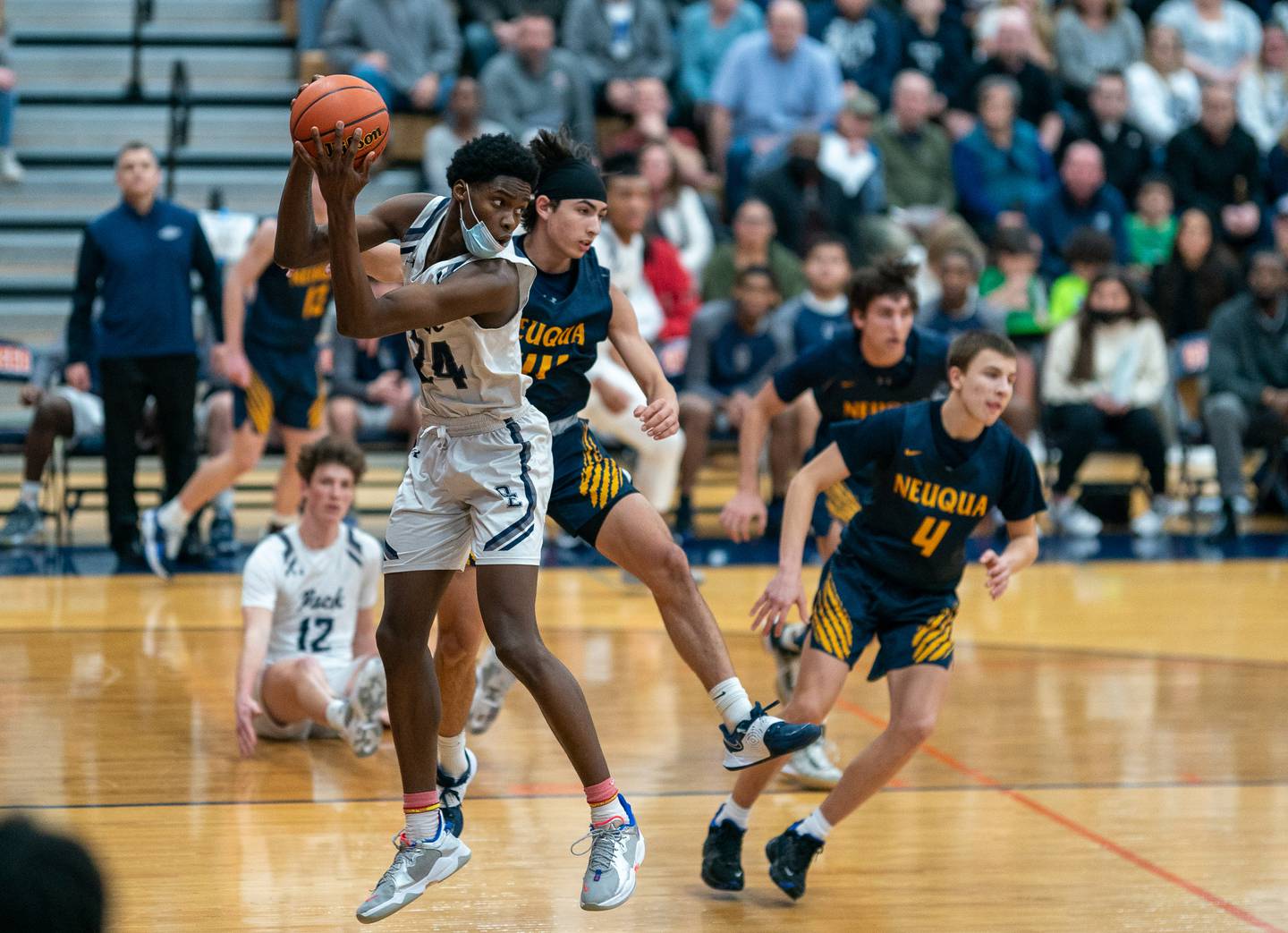Oswego East's Mekhi Lowery (24) pulls down a rebound against Neuqua Valley's Nicolas Lendino (44) during the Oswego class 4A Sectional semifinal at Oswego High School on Tuesday, March 1, 2022.