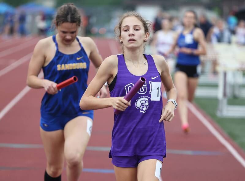 Downers Grove North's Ava Gilley (1) crosses the finish of the 4 X 800 relay during the girls varsity track and field 3A Lockport sectional on Friday, May 12, 2023.