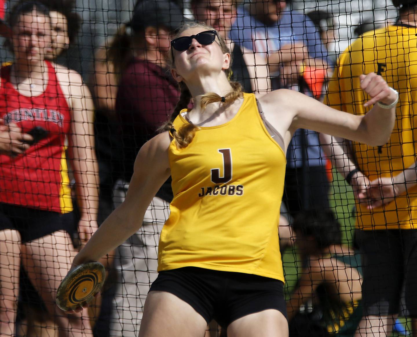 Jacobs’ Carly Uehlein throws the discus on Thursday, April 23, 2026, during the McHenry County Track and Field Meet at McCracken Field in McHenry.