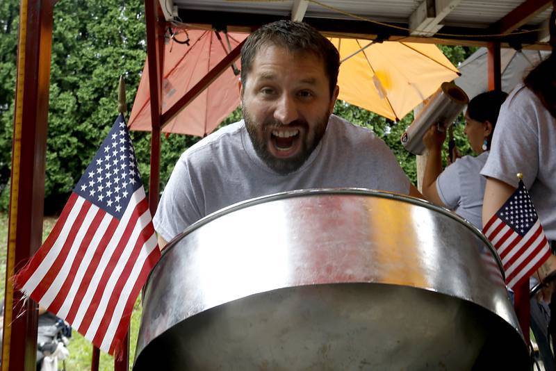 Anthony Jay Houston plays a steelpan Sunday, July 2, 2023 during Crystal Lake’s annual Independence Day Parade on Dole Avenue in Crystal Lake. This year’s parade feature close to 100 units.