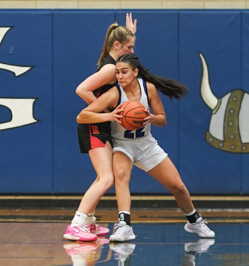 Geneva’s Leah Palmer (22) posts up against Batavia’s Reagan Sulaver (30) during a basketball game at Geneva High School on Friday, Dec 15, 2023.