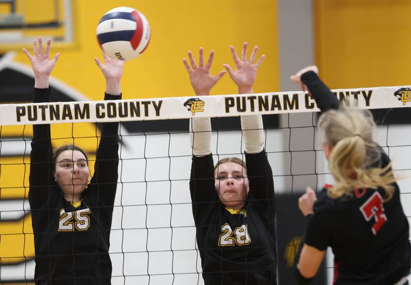 Putnam County's Alyvia Wachowiak (left) blocks a spike from Orion's Claire Haars during the Class 1A Regional final on Thursday, Oct. 30, 2025 at Putnam County High School.