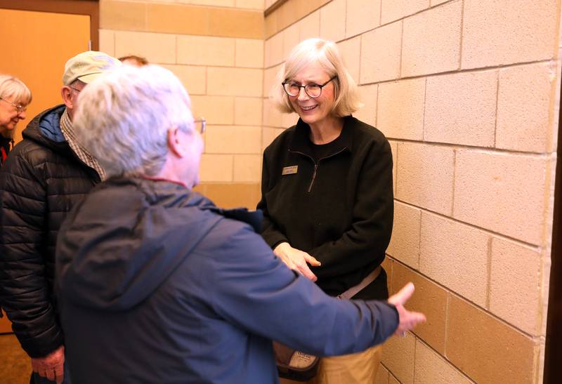 Pam Otto, a naturalist and outreach ambassador at the St. Charles Park District, greets friends and colleagues at a retirement party in her honor on Tuesday, Dec. 17, 2024 at the Hickory Knolls Discovery Center in St. Charles.