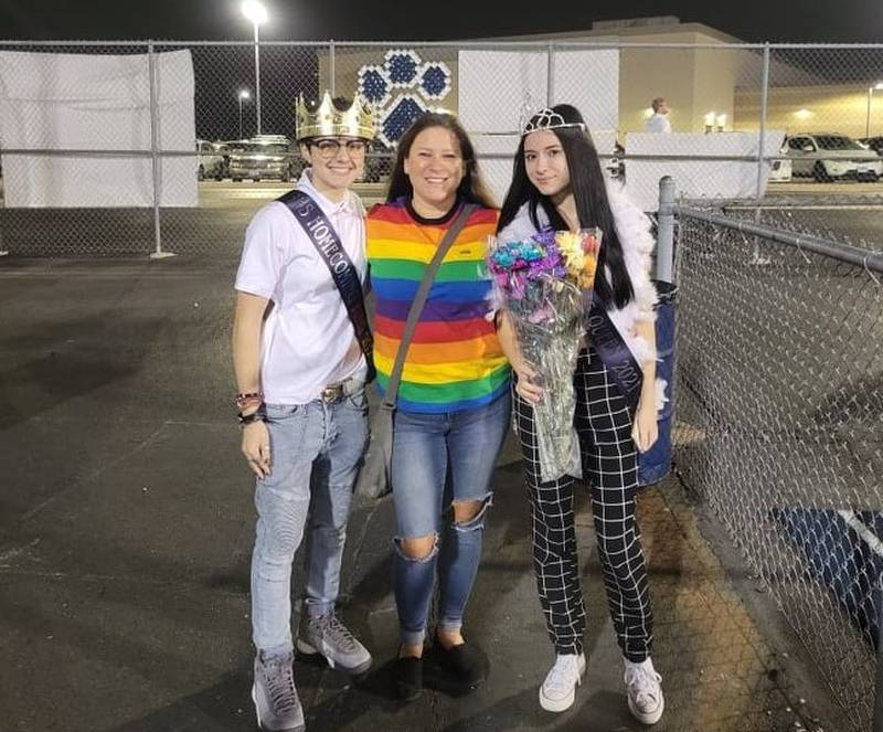 Toni Gill of Plainfield (center) stands with her daughter Emily Novak (right) and her partner Gianna Pometta at Plainfield South High School's homecoming dance on Saturday night. The girls thought they were crowned king and queen but District 202 said no one was king and queen this year; the girls were senior attendants in the court.