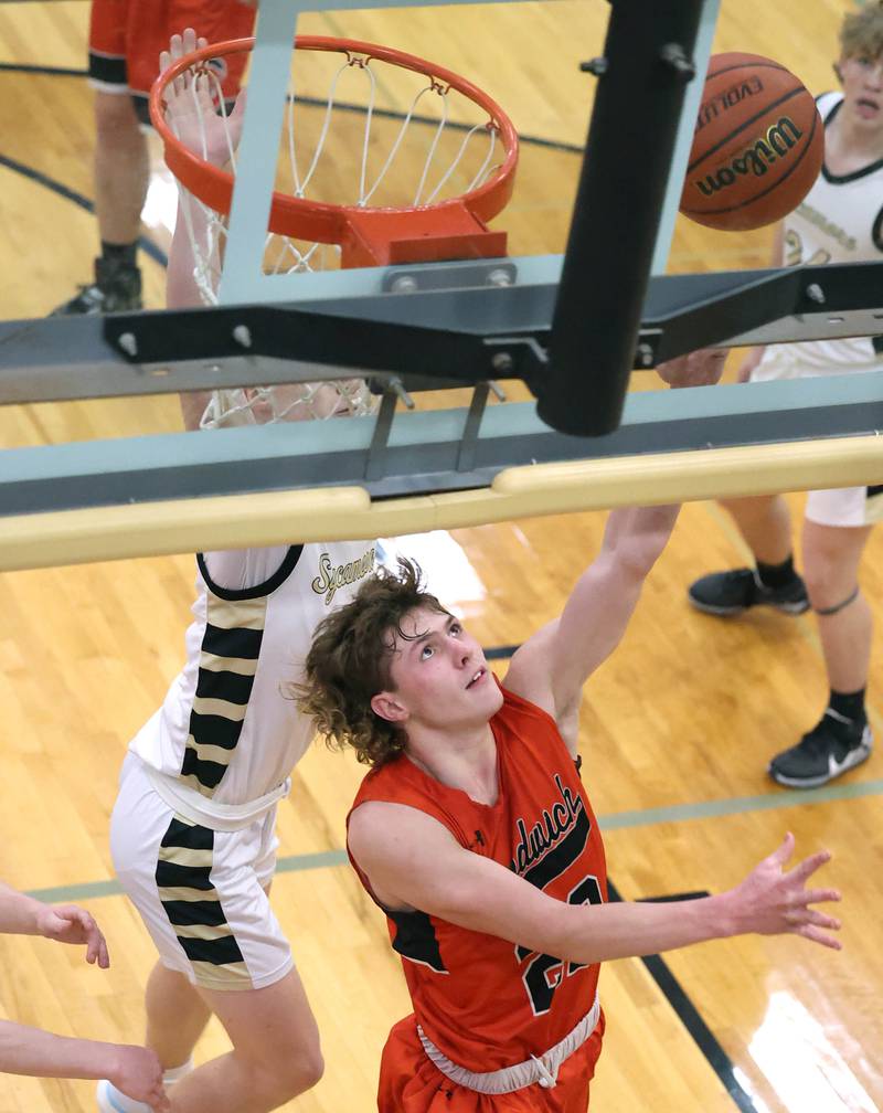 Sandwich's Austin Marks gets a layup in front of a Sycamore defender during their game Tuesday, Jan. 17, 2023, at Sycamore High School.